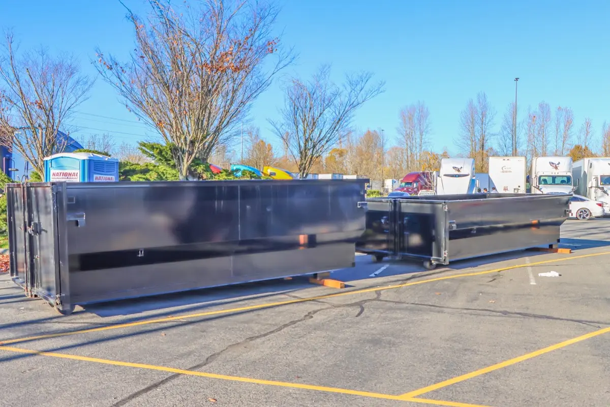 Professional dumpster rental service with roll-off container on residential driveway in Horsham